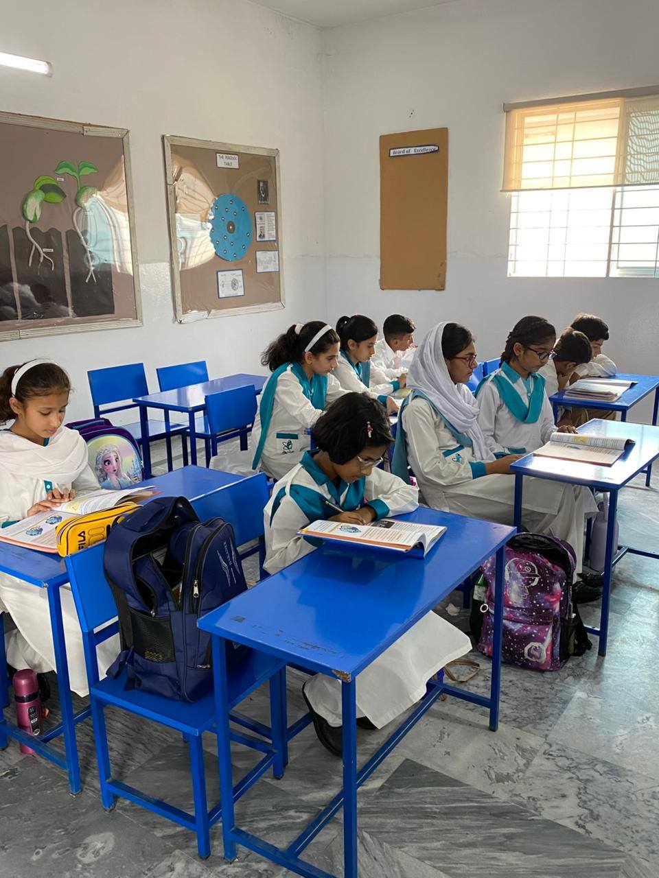 May be an image of 8 people, people studying, children's toy and text