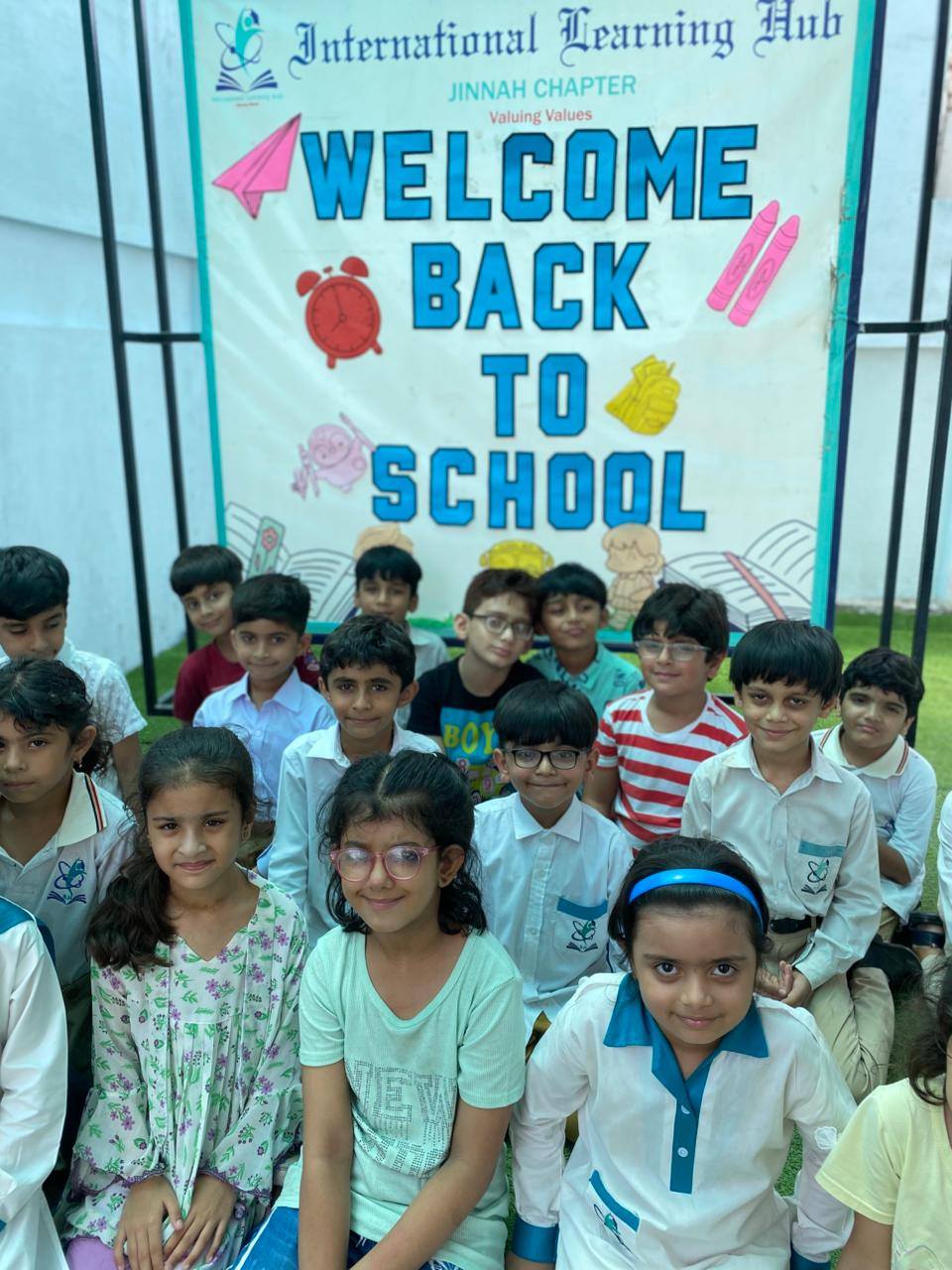 May be an image of 12 people, people smiling and text that says "International Hearning Hub JINNAH CHAPTER Valuing Values WELCOME BACK I TO SCHOOL"